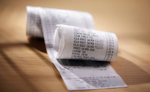 Grocery shopping list till roll printout on a wooden table