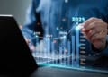 Businessman analyzes the graph of trend market growth in 2025 and plans business growth and profit increase in the year 2025. plan finances of the business