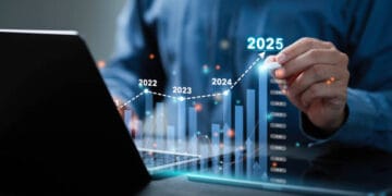 Businessman analyzes the graph of trend market growth in 2025 and plans business growth and profit increase in the year 2025. plan finances of the business