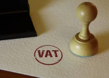 VAT stamp and stamping hand. Value-added tax and invoice payment concept.
