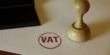VAT stamp and stamping hand. Value-added tax and invoice payment concept.